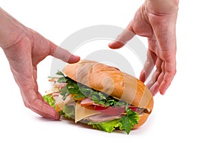 Sandwich with a ham, paprika and cheese in hands