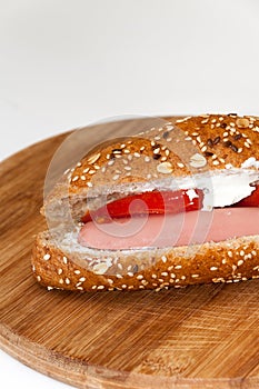 Sandwich with hot dog tomato white cheese cereals