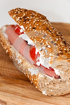 Sandwich with hot dog tomato white cheese cereals