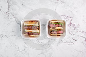 Sandwich katsu sando with beef. wagyu katsu. japanese cuisine traditional food. Trendy fast food at marble background photo