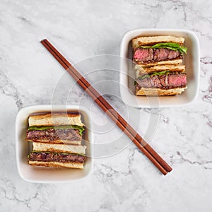 Sandwich katsu sando with beef. wagyu katsu. japanese cuisine traditional food. Trendy fast food at marble background