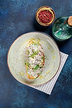 Sandwich with lingonberry and omul on a white round plate