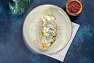 Sandwich with lingonberry and omul on a white round plate