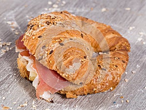 Sandwich made with croissant cheese and Parma ham