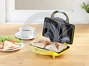 Sandwich maker machine in the kitchen