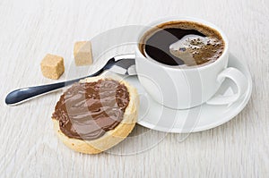Sandwich with nut-chocolate paste, black coffee, sugar and spoon