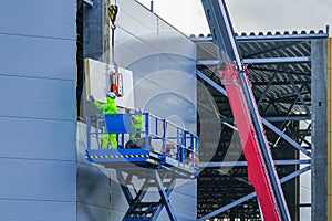 Sandwich panels wall mounting using crane and scissor lift