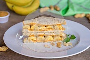 Sandwich with peanut butter and banana on plate