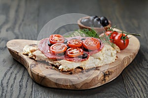 Sandwich with pita bread salami and vegetables on