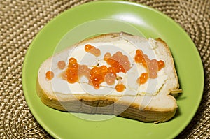 sandwich with red caviar on a plate