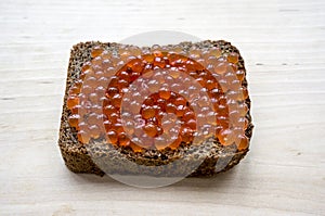 Sandwich with red caviar and rye bread