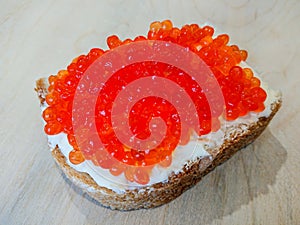 Sandwich with red caviar. White bread with butter. Seafood delicacies