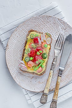 Sandwich with salmon and omelet with green peas and cucumber