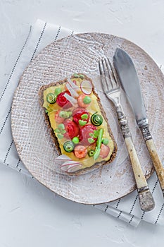 Sandwich with salmon and omelet with green peas and cucumber