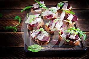 Sandwich with salted herring and slice beetroot on the toasts