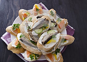 Sandwich, sandwich with salmon and sprats on a plate. Macro background. High quality photo. Banquet