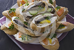 Sandwich, sandwich with salmon and sprats on a plate. Macro background. High quality photo. Banquet