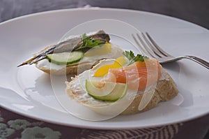 Sandwich, sandwich with salmon and sprats on a plate. Macro background. High quality photo. Banquet