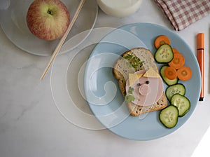 Sandwich with sausage, cucumber i  n a plate eating