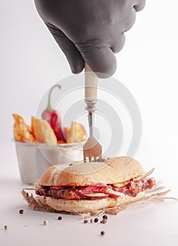 Sandwich on a white background with chili french fries and