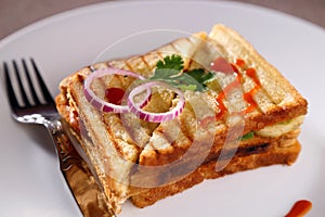 A sandwich in a white ceramic plate with sauce