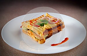 A sandwich in a white ceramic plate with sauce