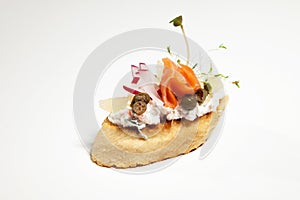 Sandwich with white cheese, salmon, radish and sprouts on the white background