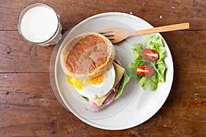 Sandwich in white dish on wooden table