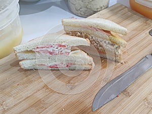 Sandwich on wooden chopping board. Crab Stick Sandwich , Flossy Pork Sandwich.