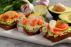 Sandwiches with avocado spread and smoked salmon.