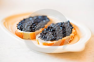 Sandwiches with black sturgeon or beluga caviar close up