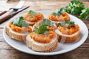 Sandwiches with bread zucchini caviar tomatoes onions. Homemade vegetarian food. Canned stewed vegetable. wooden background