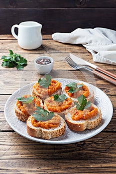 Sandwiches with bread zucchini caviar tomatoes onions. Homemade vegetarian food. Canned stewed vegetable. wooden background