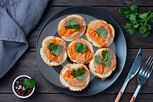 Sandwiches with bread zucchini caviar tomatoes onions. Homemade vegetarian food. Canned stewed vegetable. wooden background