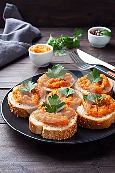 Sandwiches with bread zucchini caviar tomatoes onions. Homemade vegetarian food. Canned stewed vegetable. wooden background