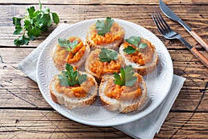 Sandwiches with bread zucchini caviar tomatoes onions. Homemade vegetarian food. Canned stewed vegetable. wooden background