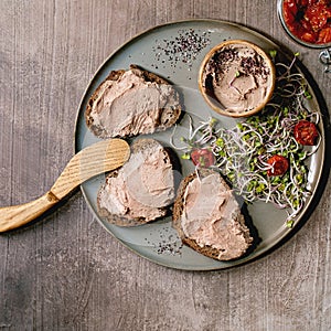 Sandwiches and ceramic bowl of homemade chicken liver pate