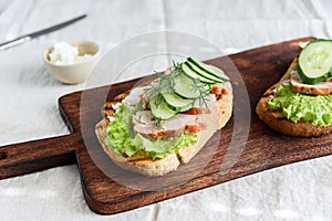 Sandwiches with chicken meat, cucumber, lettuce  and soft cheese