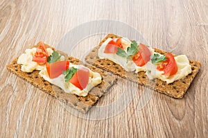 Sandwiches from crispbread with melted cheese, tomatoes, parsley