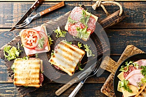 Sandwiches with grilled toast ham salami cheese tomatoes and lettuce