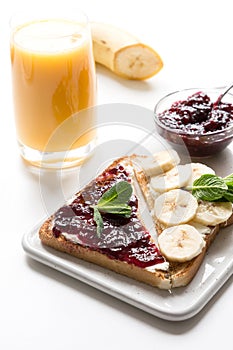 Sandwiches for healthy breakfast with berry jam, bananas.