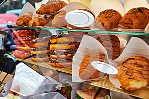 sandwiches, hot dogs and croissants in the refrigerated display case of the diner