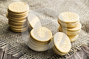 Sandwiches made from cookies and ice cream with condensed milk on a table with burlap