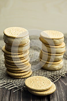 Sandwiches made from cookies and ice cream with condensed milk on a table with burlap