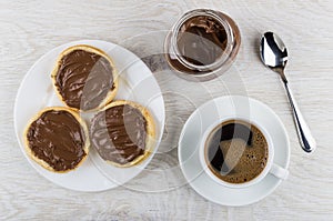 Sandwiches with nut-chocolate paste, black coffee and spoon