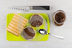 Sandwiches with nut-chocolate paste, bread on cutting board