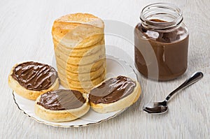 Sandwiches with nut-chocolate paste, bread, jar of paste