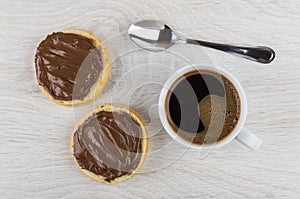 Sandwiches with nut-chocolate paste, coffee in cup and spoon