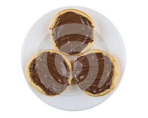 Sandwiches with nut-chocolate paste in white plate on white