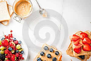 Sandwiches with peanut butter, berry and fruit